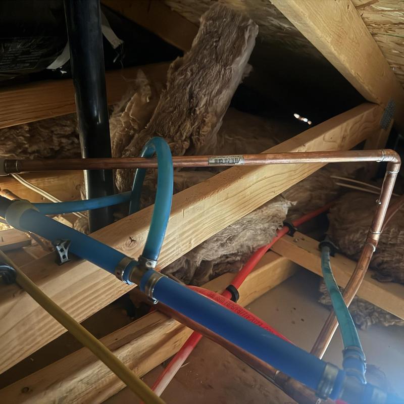 Copper and PEX water supply lines in attic framing