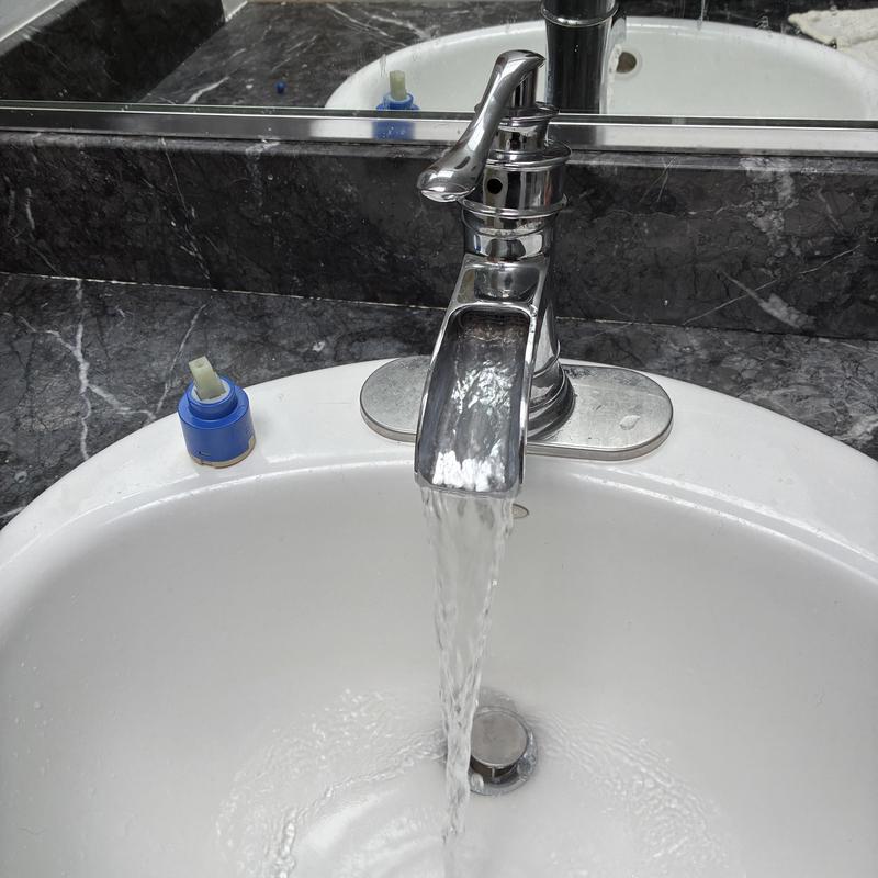 Bathroom sink faucet cartridge replacement with water flow