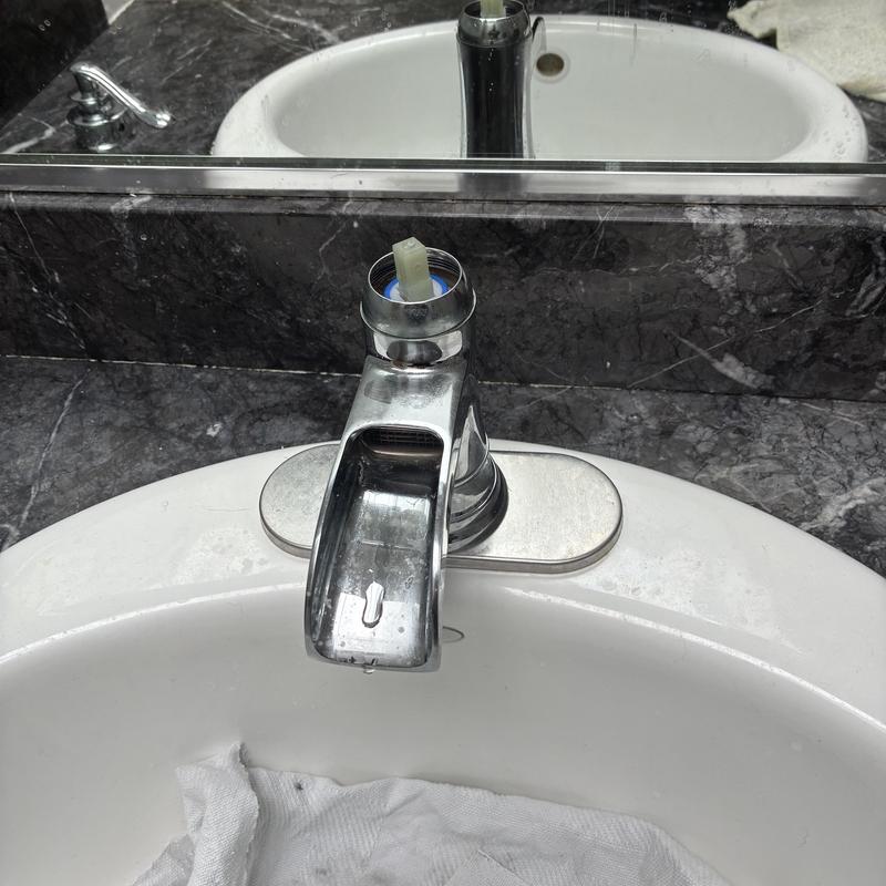 Bathroom sink faucet cartridge removed for repair