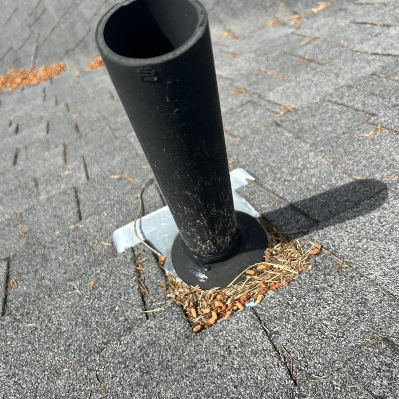 Roof vent pipe with damaged flashing and debris buildup Roof vent pipe with damaged flashing and debris buildup