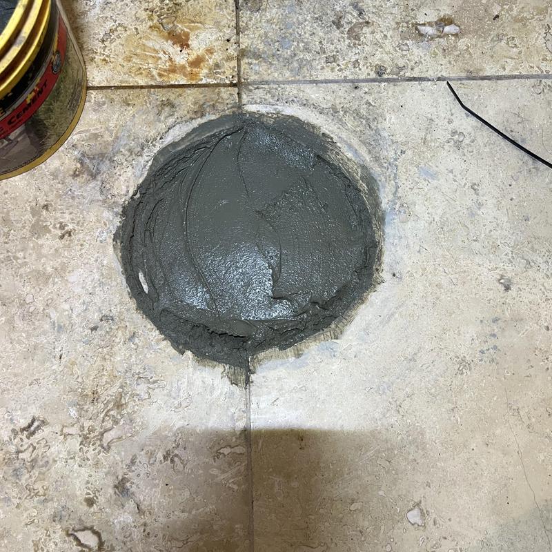 Sewer line capped with concrete in tiled floor