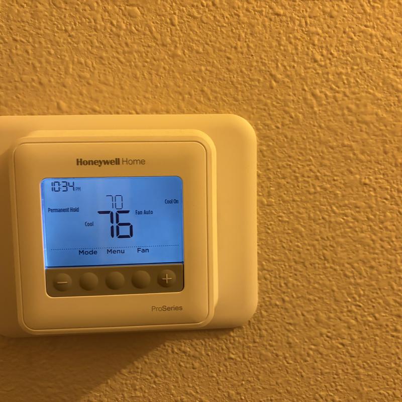 Honeywell Home thermostat set to 76°F cooling mode Honeywell Home thermostat set to 76°F cooling mode