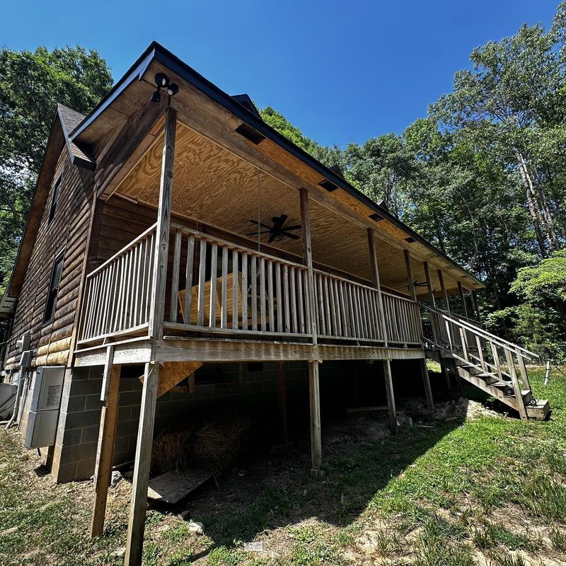 Wooden porch structure and railing before rebuild