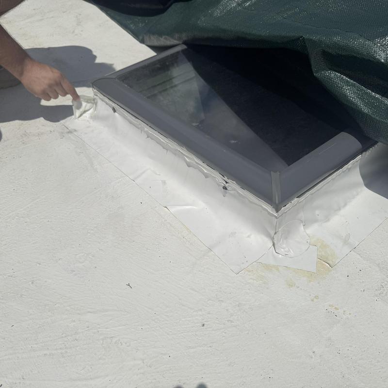 TPO roofing around damaged skylight being replaced