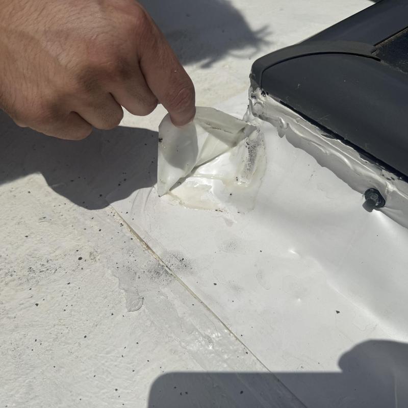 TPO roofing membrane peeling near skylight flashing