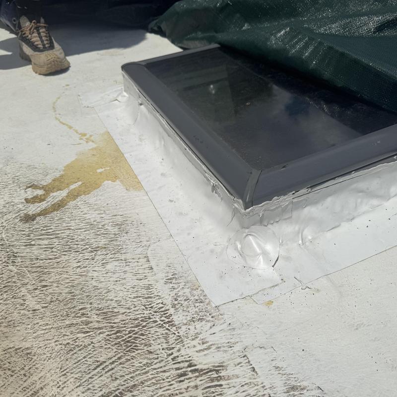 TPO roofing patch around skylight repair site
