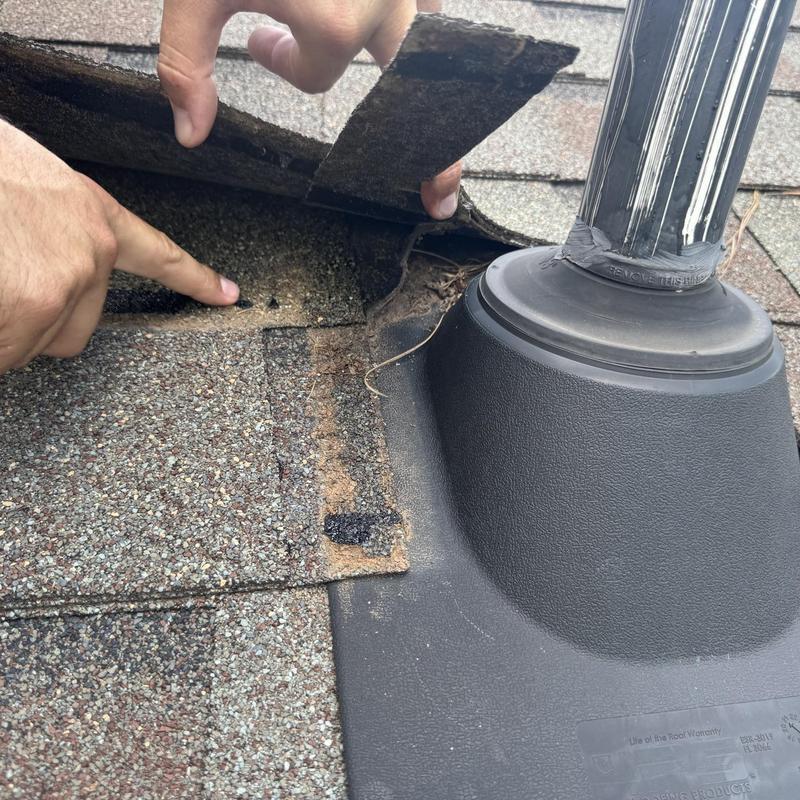 Asphalt shingle roof vent pipe flashing leak inspection