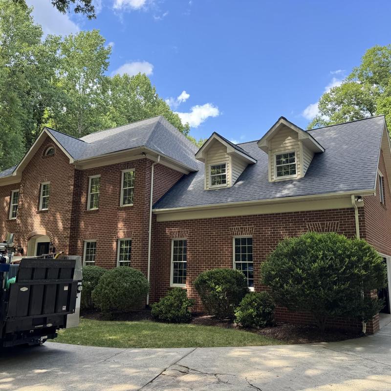 Roof shingles and gutter system inspection on brick home