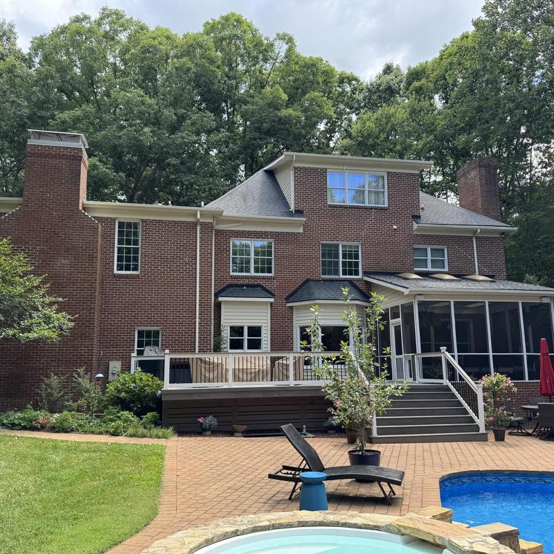 Roof shingles and gutter inspection on brick home