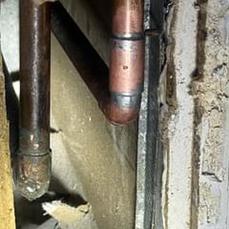 Copper water pipe leak from drywall screw puncture