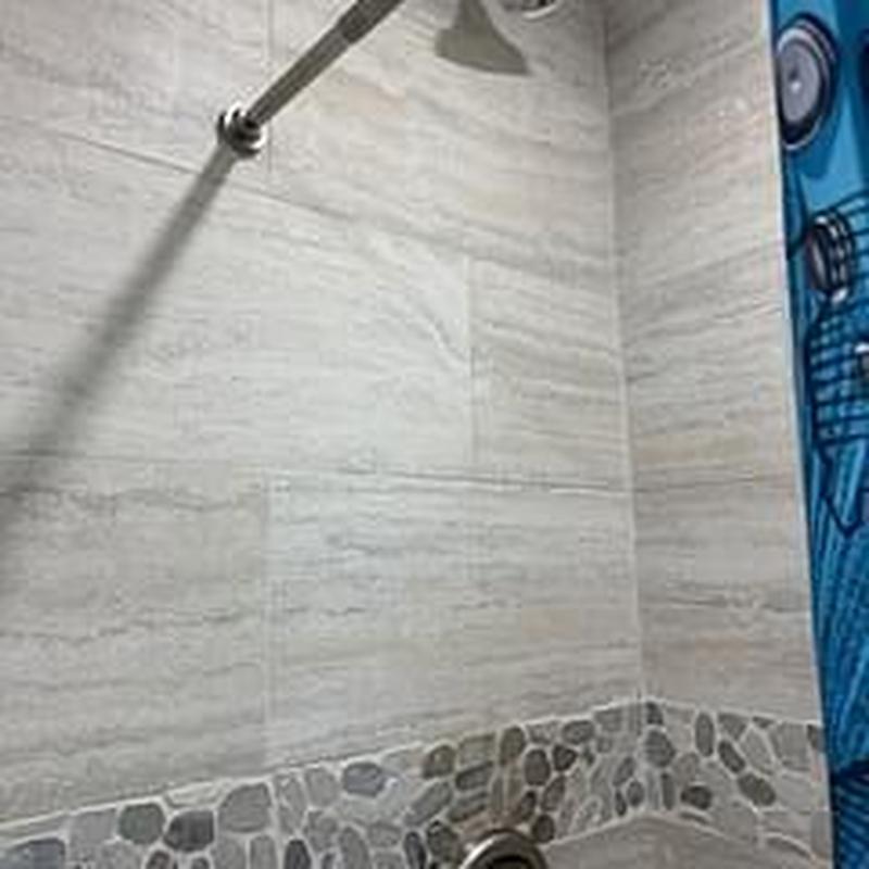 Shower trim and tile with stone accent wall