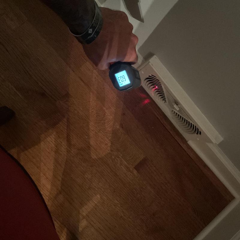 HVAC floor vent temperature check with laser thermometer