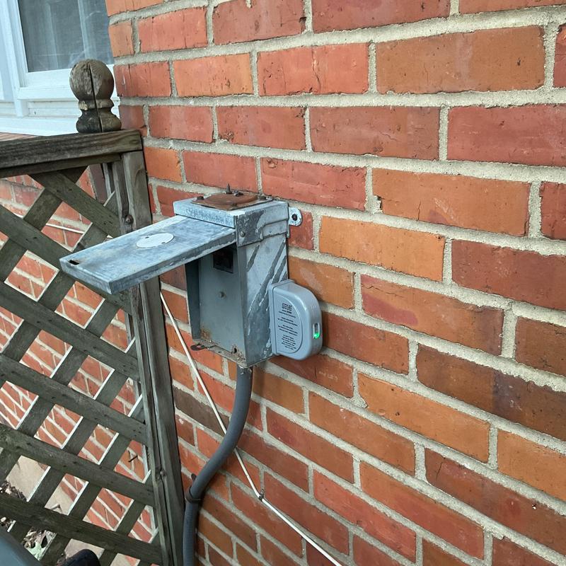 Surge protector installed on outdoor metal junction box