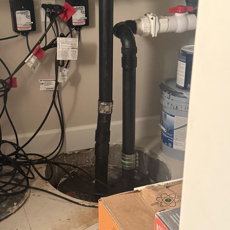 Sump pump discharge pipes with valve and clamps
