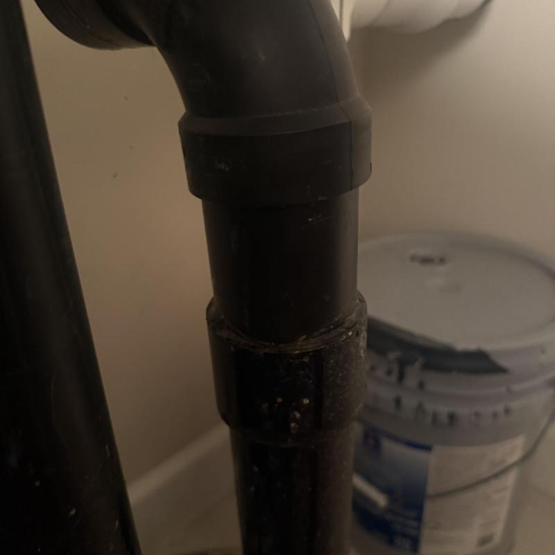 Sump pump black ABS pipe joint with sealant applied