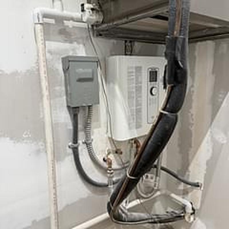 Tankless water heater piping reroute in utility room Tankless water heater piping reroute in utility room