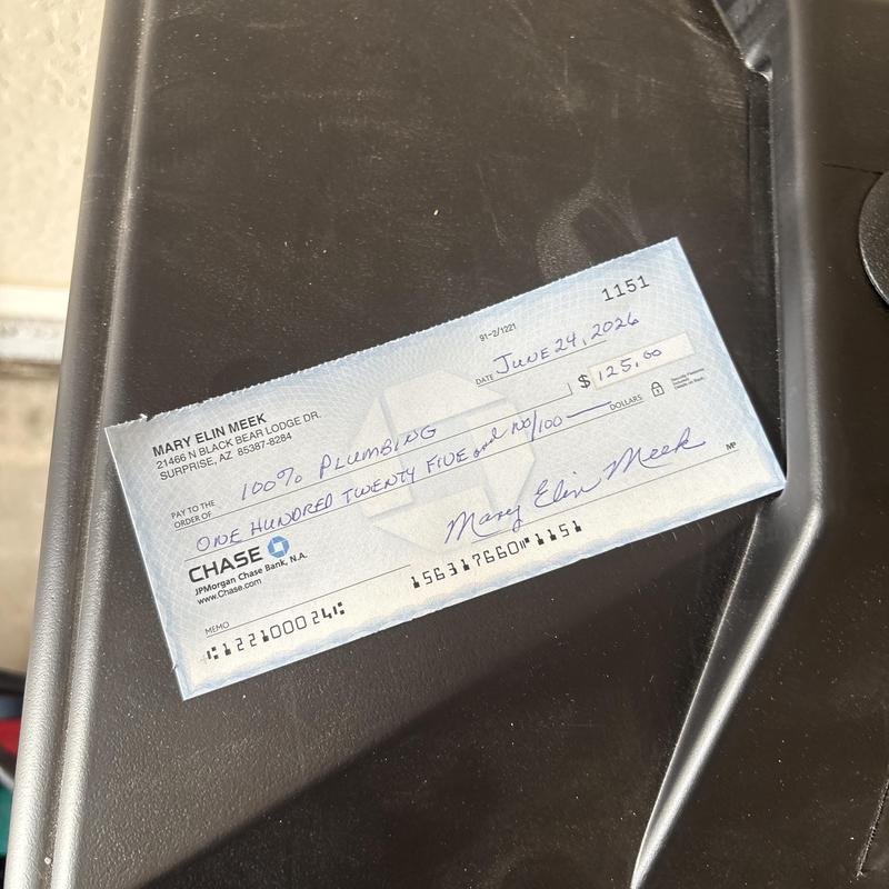 Plumbing service payment check on black surface