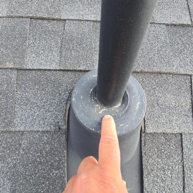 Roof pipe jack with worn seal on shingle roof