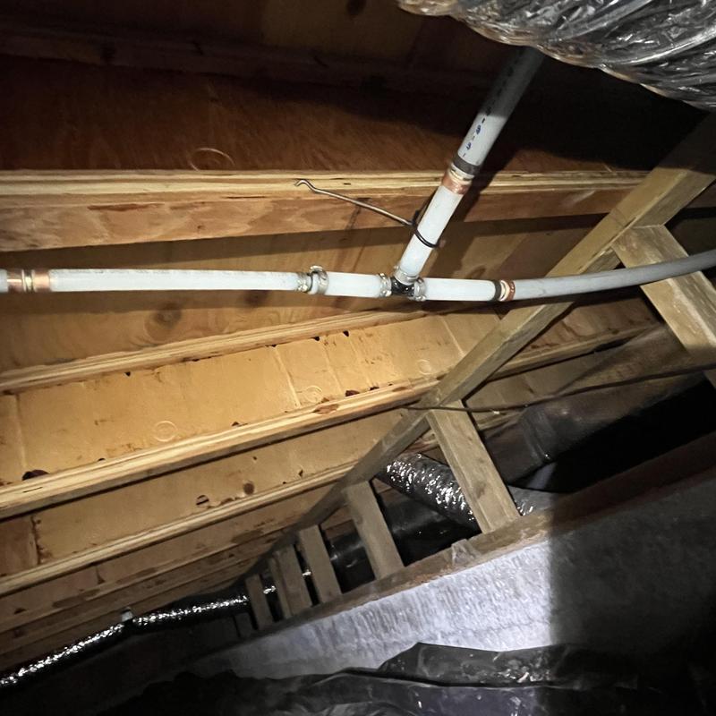 Polybutylene piping in crawlspace with pipe fittings