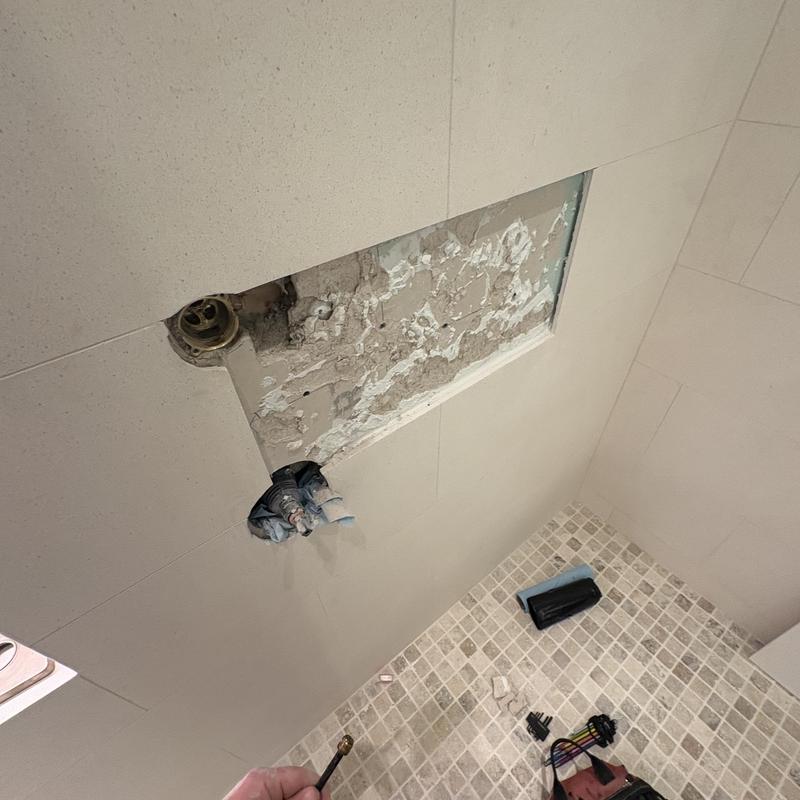 Shower valve plumbing repair with wall tile removal