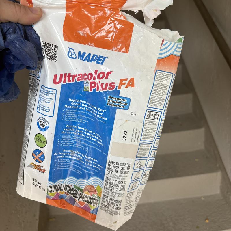 Tile grout bag held during home repair in Glendale, AZ