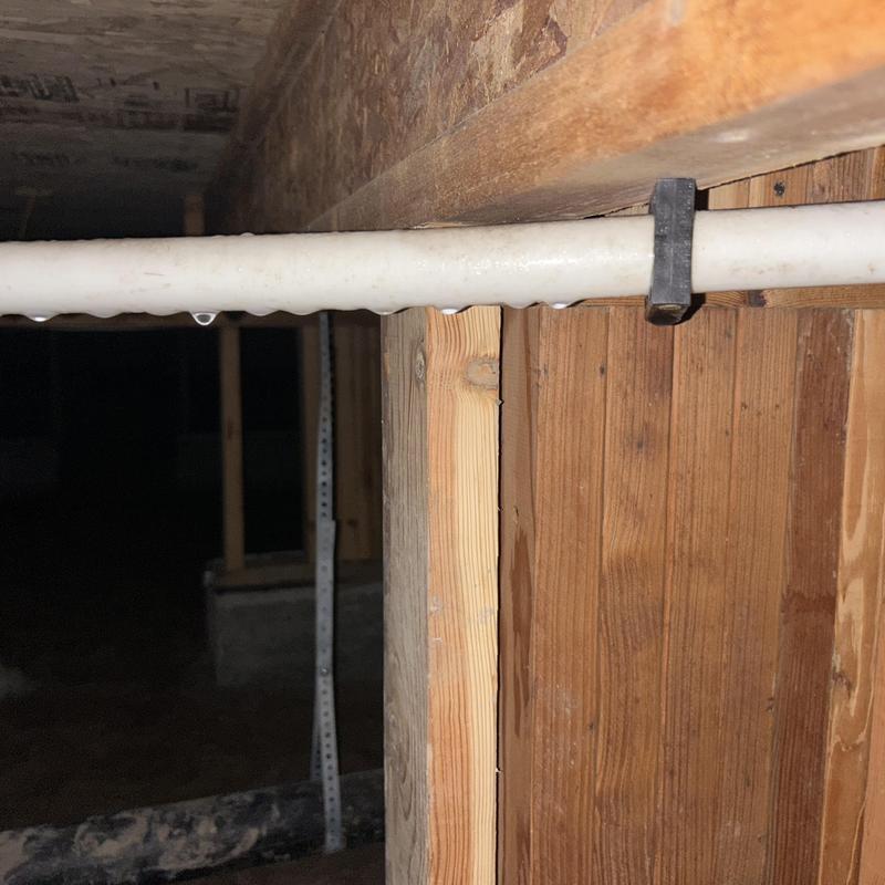 PVC pipe with water droplets in crawl space foundation