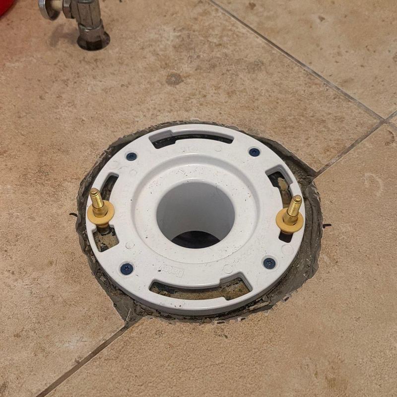 Twist lock flange installed in tiled bathroom floor Twist lock flange installed in tiled bathroom floor