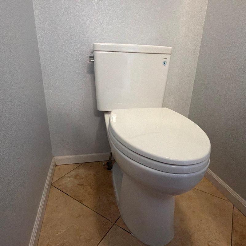 Toilet installation in bathroom corner with tile floor Toilet installation in bathroom corner with tile floor