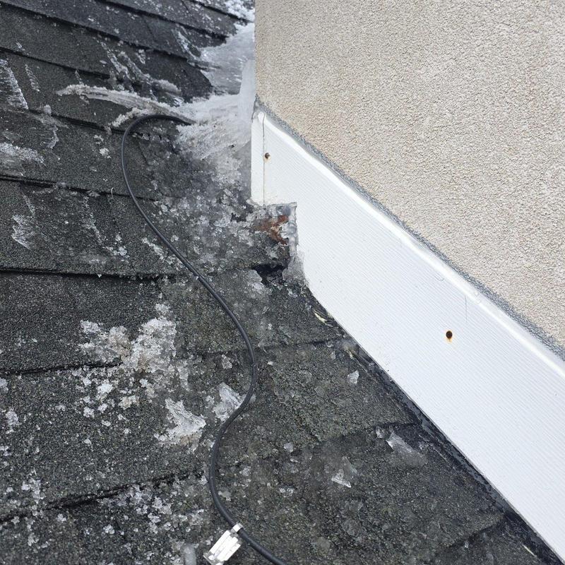 Roof shingles with hail damage near wall flashing