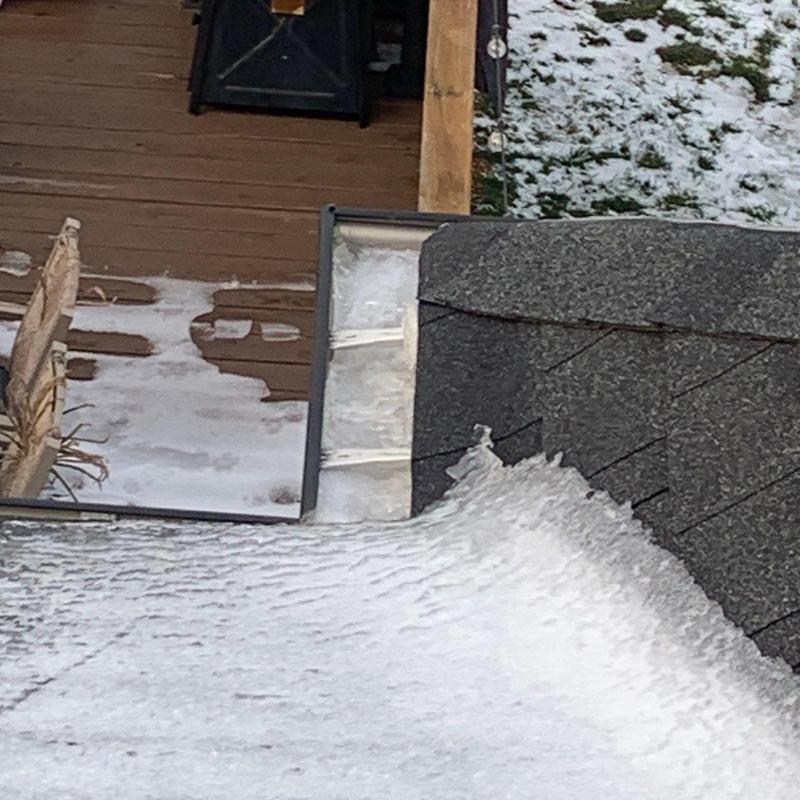 Roof flashing with hail damage and snow buildup