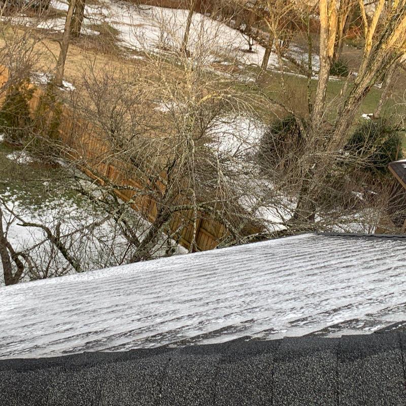 Roof shingles with hail damage and ice buildup