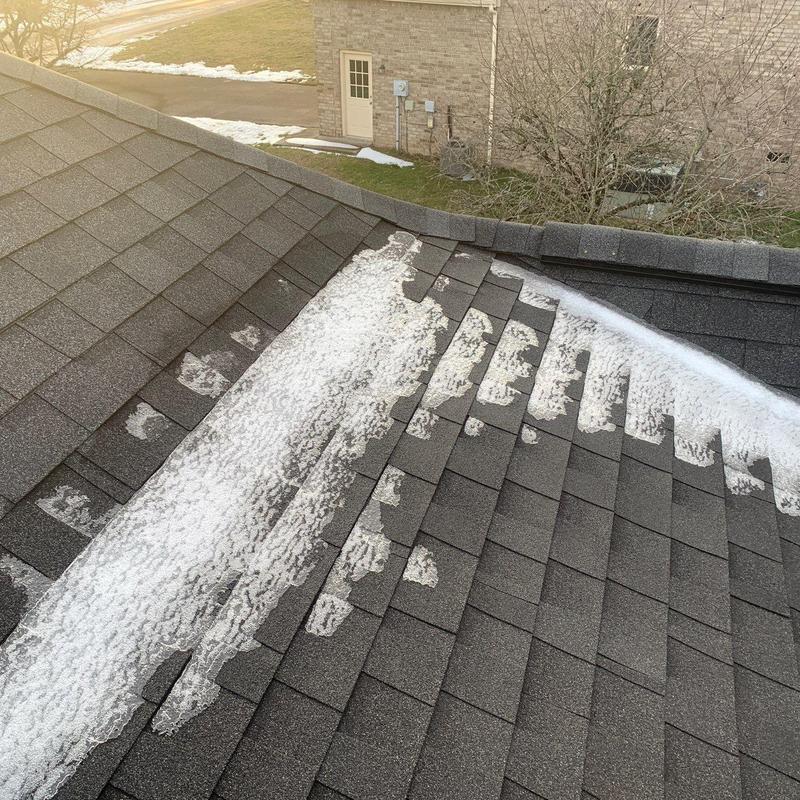 Asphalt shingle roof with hail damage and ice buildup
