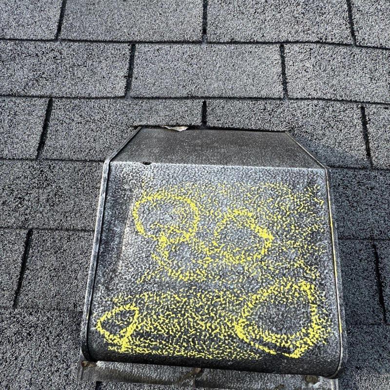 Roof vent with hail damage marked for repair