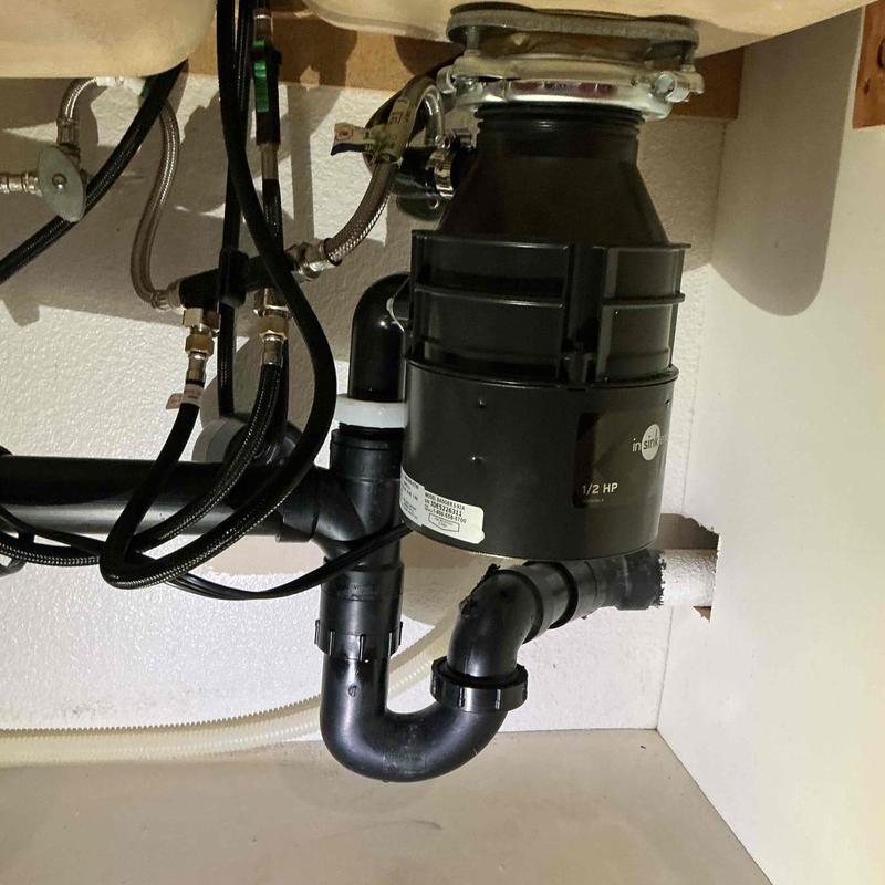 Garbage disposal connected to waste arm and drain hose