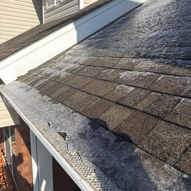 Roof shingles with hail damage and ice buildup