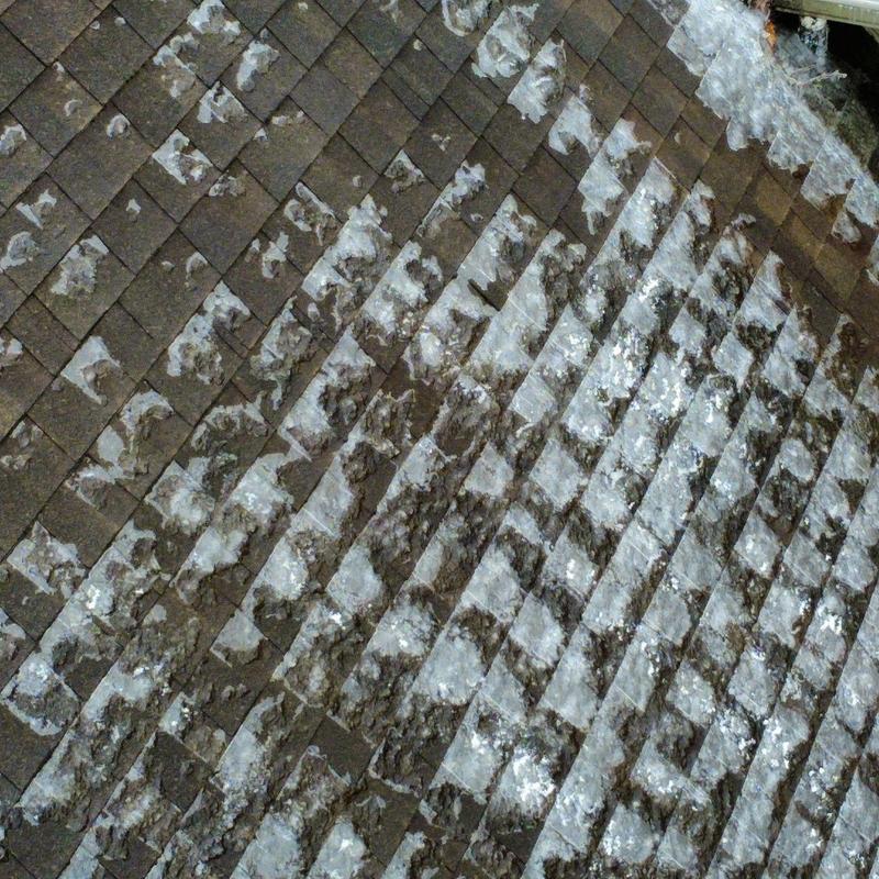 Roof shingles with hail damage and wear marks
