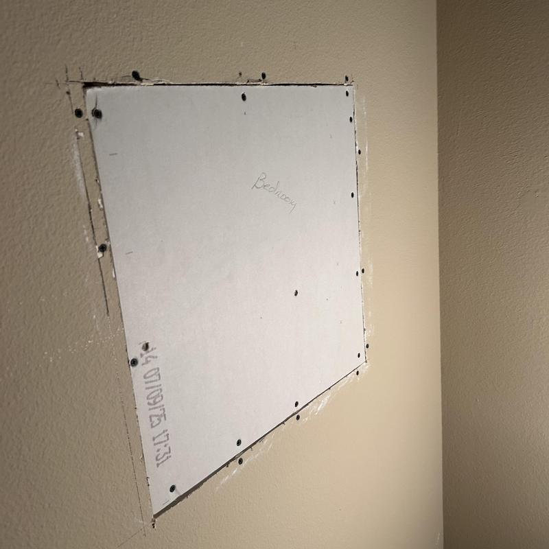 Drywall access panel for shower valve replacement in bedroom wall Drywall access panel for shower valve replacement in bedroom wall
