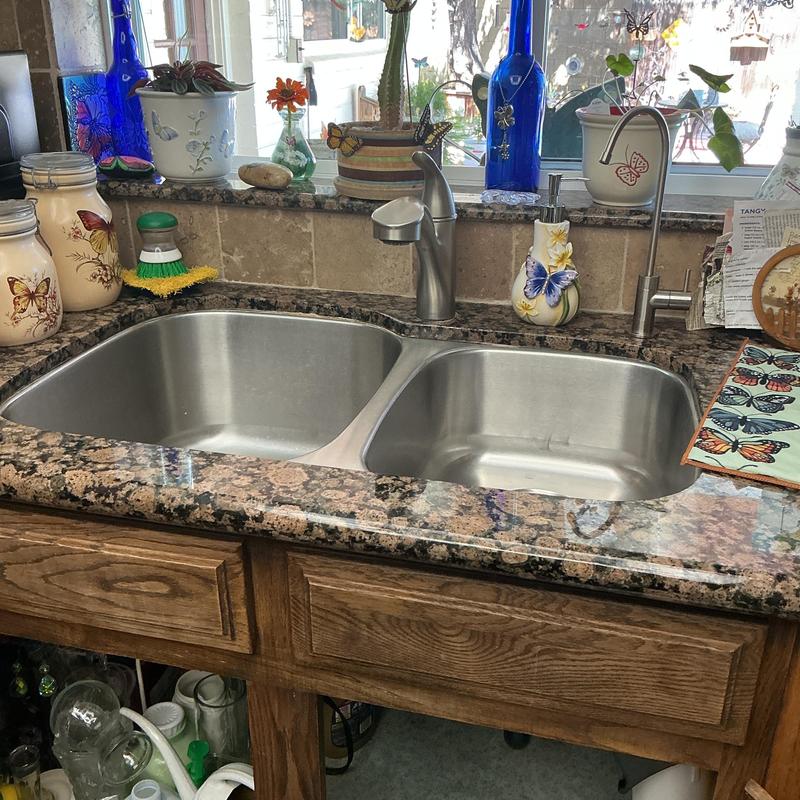 Double stainless steel kitchen sink with granite countertop