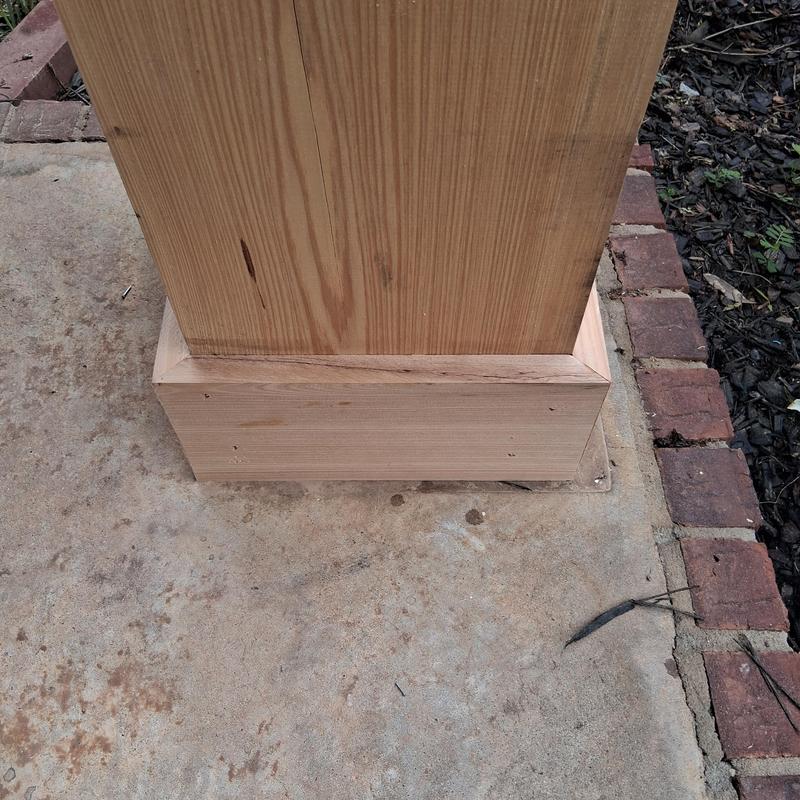 Column base trim installation on concrete patio Column base trim installation on concrete patio