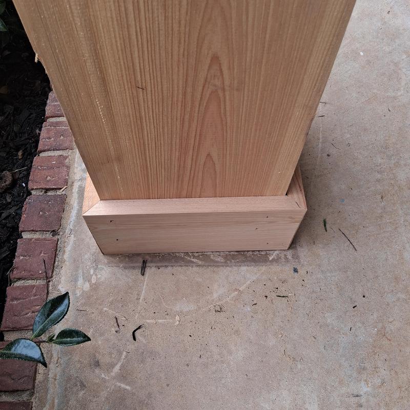 Wood column trim installation on concrete porch base Wood column trim installation on concrete porch base