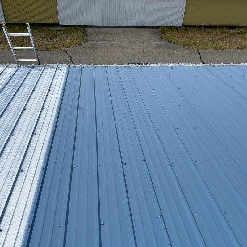 Metal roof panels with screws and ladder nearby Metal roof panels with screws and ladder nearby