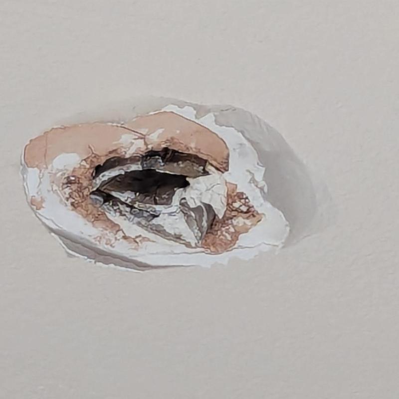 Ceiling drywall hole with water damage and cracking Ceiling drywall hole with water damage and cracking