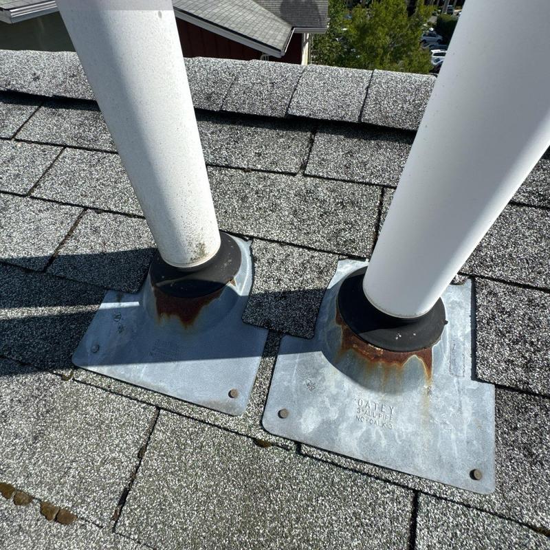 Roof vent pipe flashing with rust on shingles