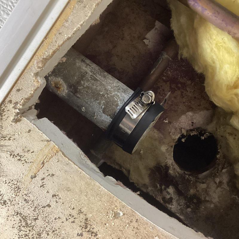 Sink drain pipe with installed cap and clamp