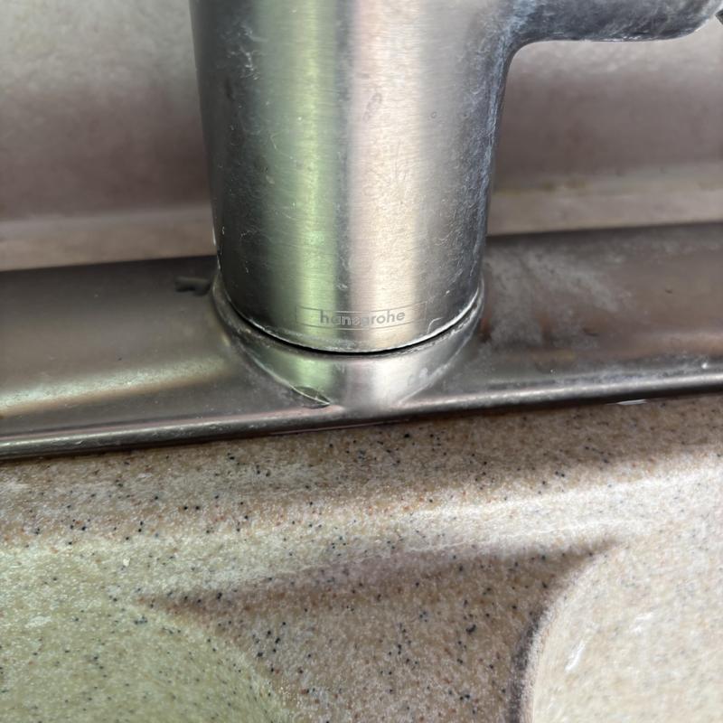 Kitchen faucet base with water leak on sprayer hose