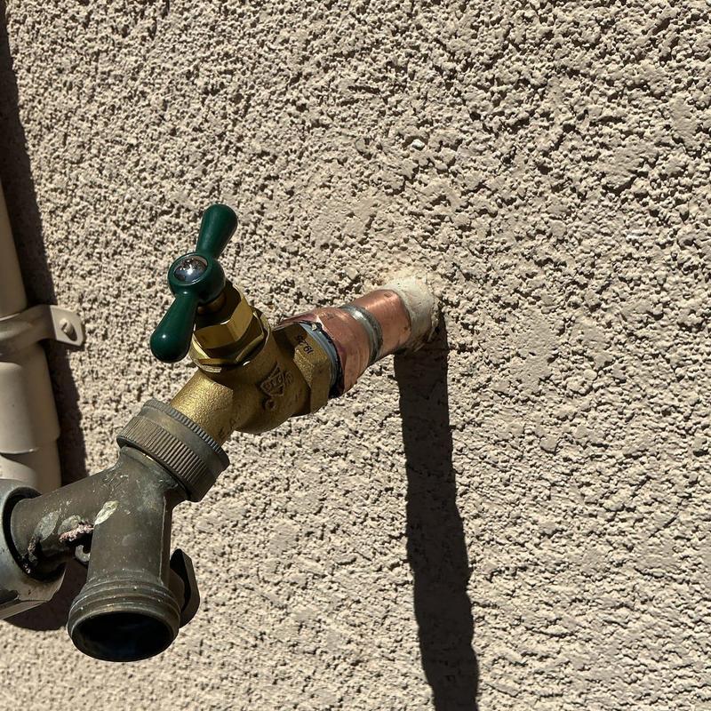34 hose bib with brass valve on stucco wall