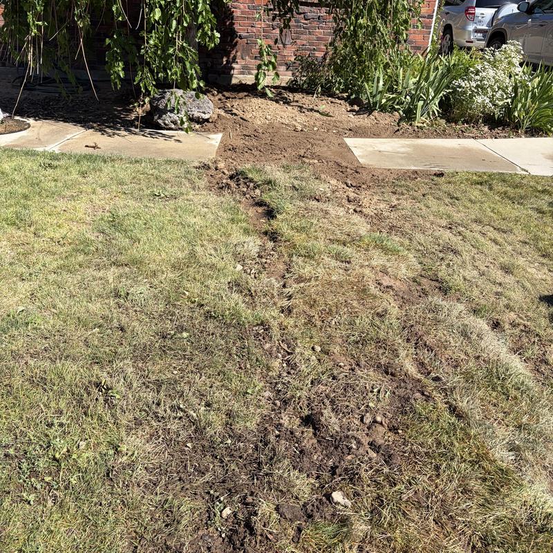 Water main installation trench with backfilled soil