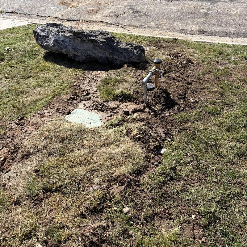 Water main installation with exposed valve and meter box