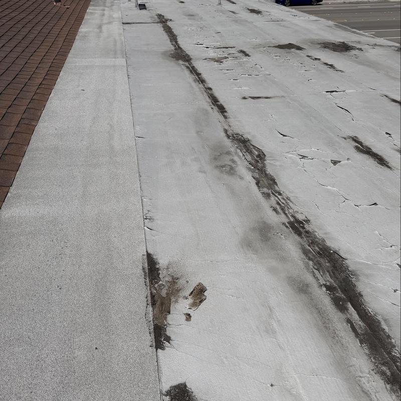 Flat roof membrane with damaged and cracked areas Flat roof membrane with damaged and cracked areas