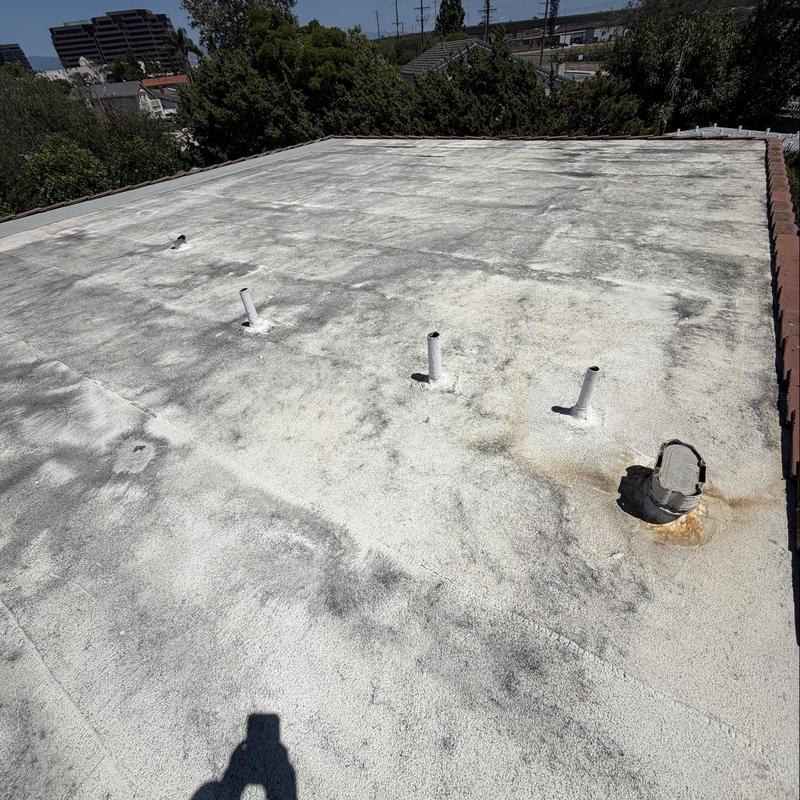 Flat roof surface with vent pipes and waterproofing membrane Flat roof surface with vent pipes and waterproofing membrane